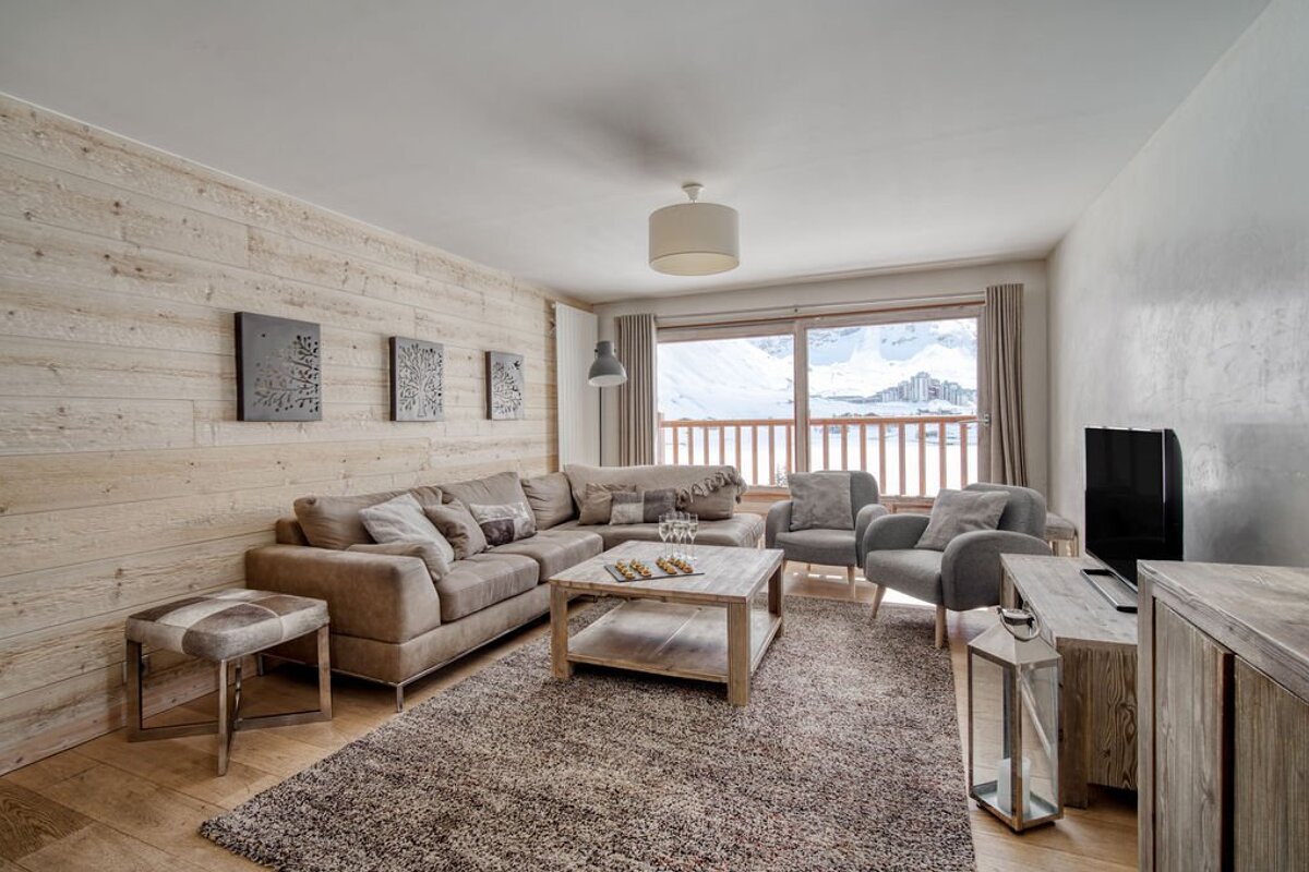 A living room with a couch and two chairs