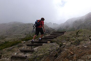 An image of a hiker on a mountain trail on a misty day near chamonix mont blanc