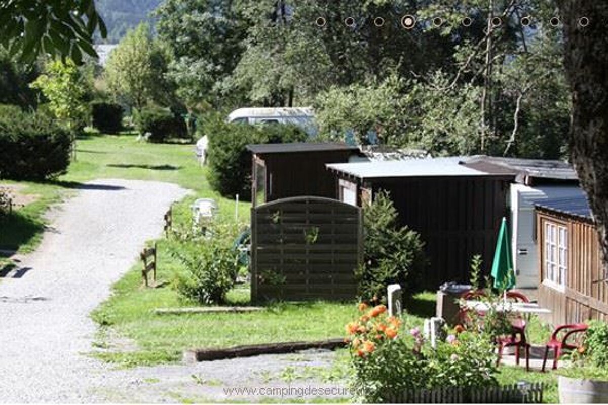 a path in a campsite with small chalets