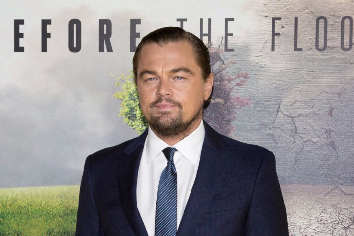leonardo dicaprio infront of a film poster