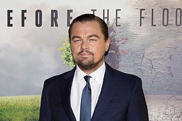 leonardo dicaprio infront of a film poster