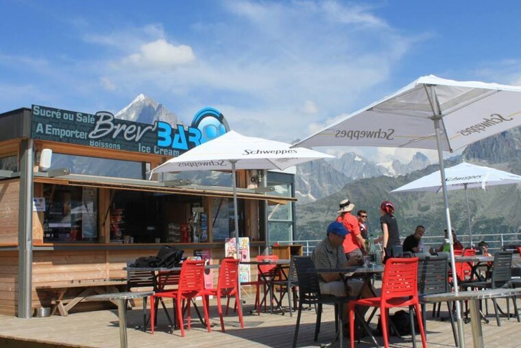 People sit at tables outside of a brew bar