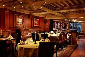A dining room with tables and chairs and candles