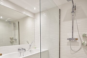 A bathroom with a bathtub and a shower