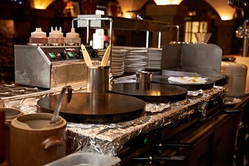 A kitchen with a few utensils and sauce bottles