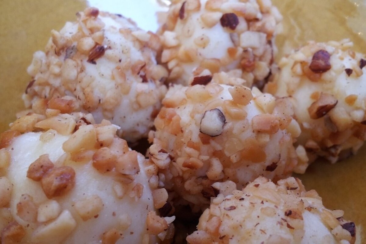 a bowl of nut covered truffles