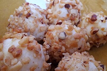 a bowl of nut covered truffles