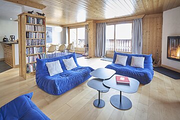 A living room with blue furniture and a fireplace