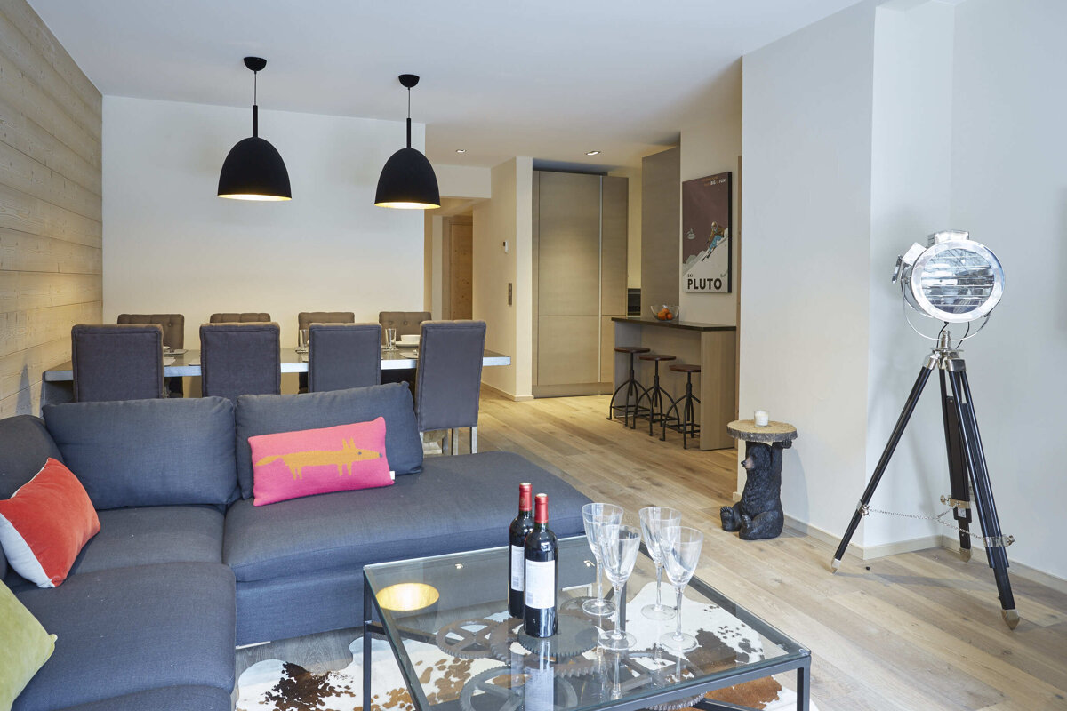 A living room with a poster on the wall that says pluto