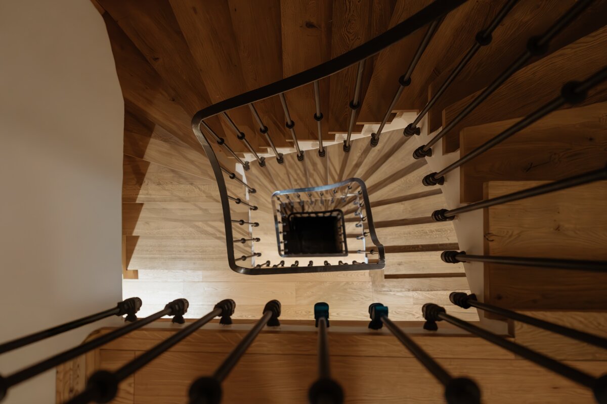 Looking down a spiral staircase with a black railing