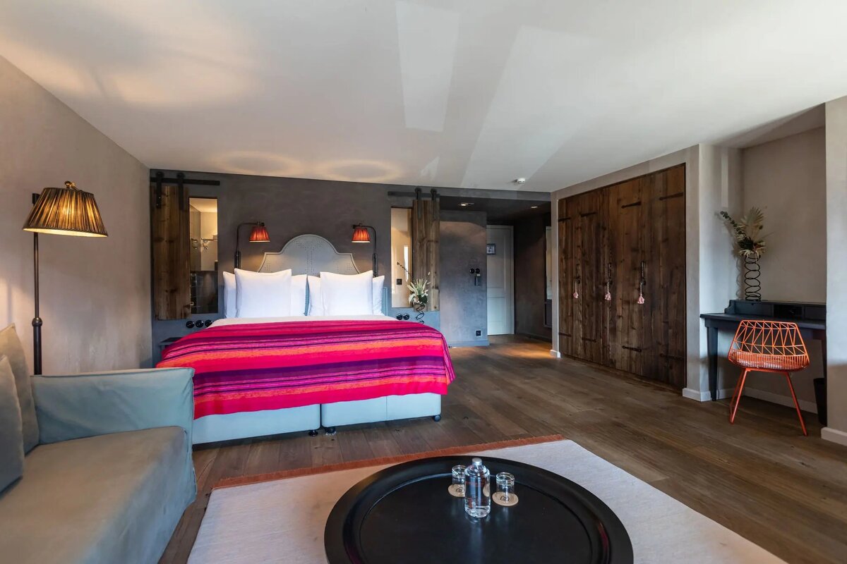 A hotel room with a large bed and a couch