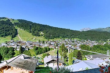 A view of a small town with a mountain in the background