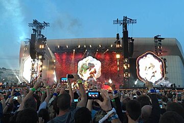 A crowd of people taking pictures of a concert with their phones