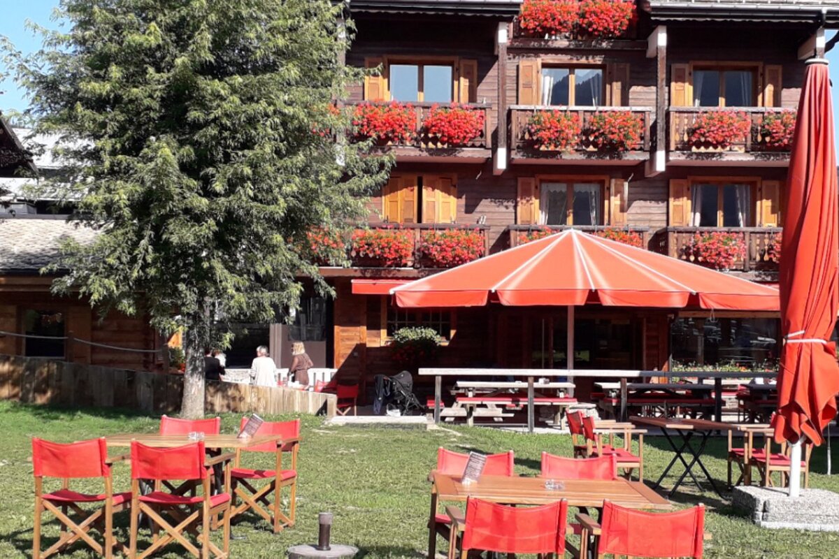 A large red umbrella sits in front of a restaurant