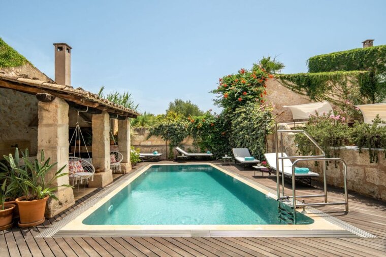 A large swimming pool in the backyard of a house