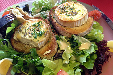 a plate of salad topped with goats cheese