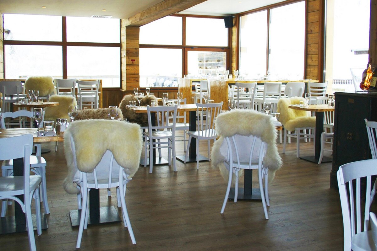 A restaurant with tables and chairs covered in fur