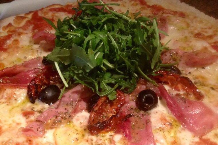 a pizza with rocket on top