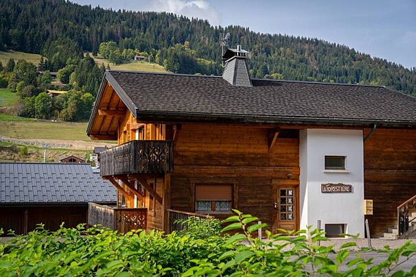 A wooden house with a sign that says la forestiere
