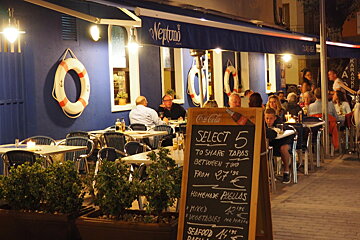 the exterior of a restaurant with a chalk board