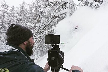 a man filming powder shots