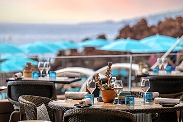 A table with a potted plant and glasses on it