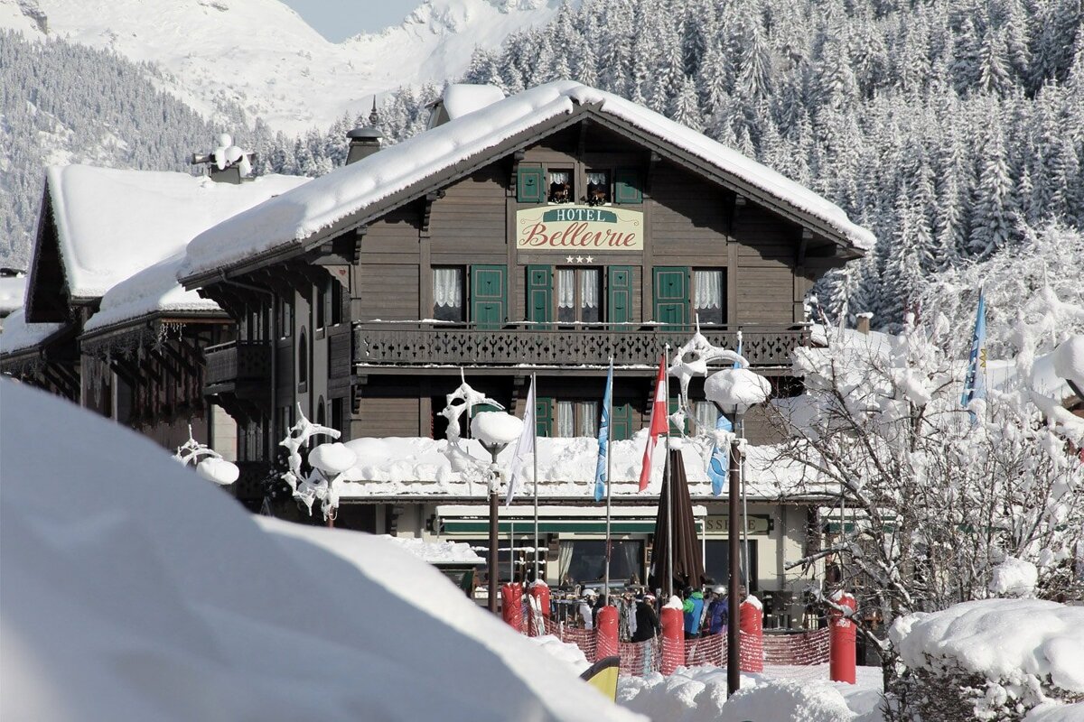 A hotel called bellevue is covered in snow