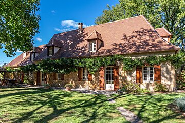 A large house with a lot of windows and shutters