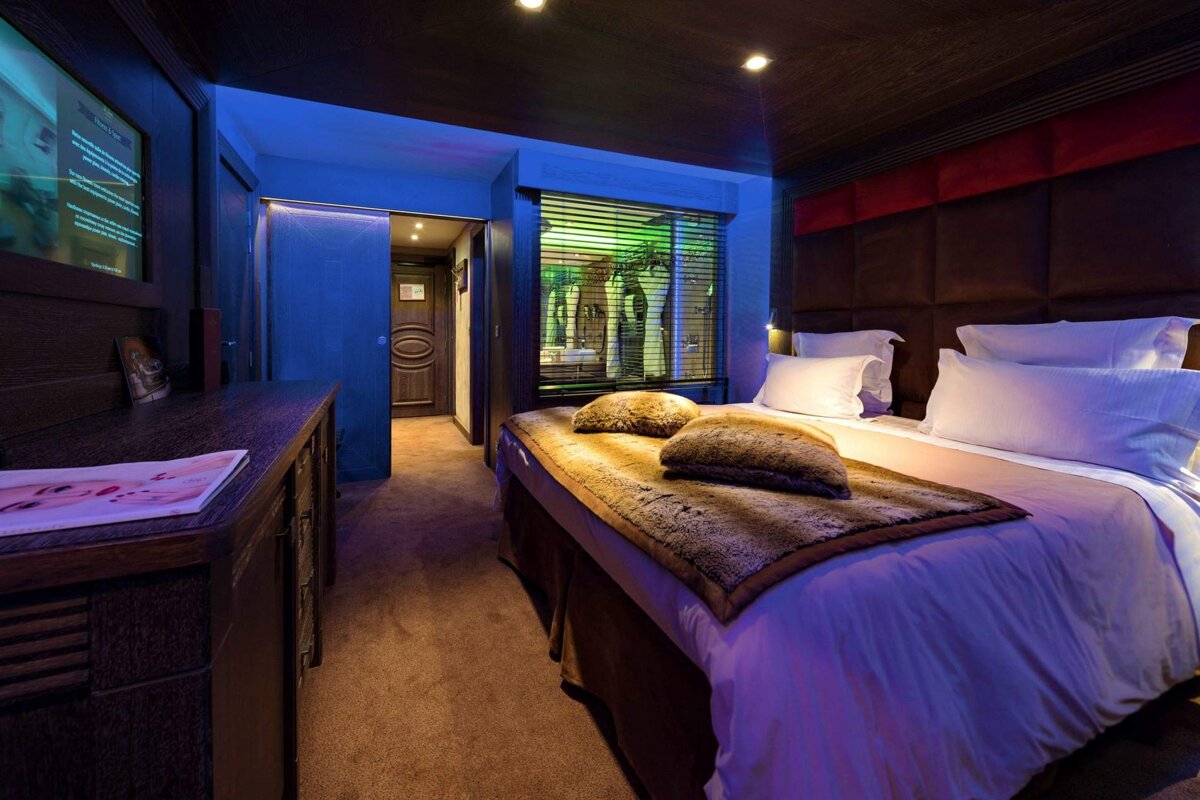 A hotel room with a large bed and a television