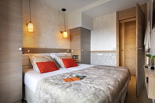 A bedroom with a bed and a magazine on the bed