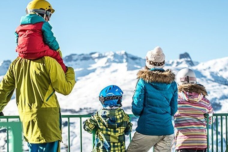 a family looking at the snowy mountains