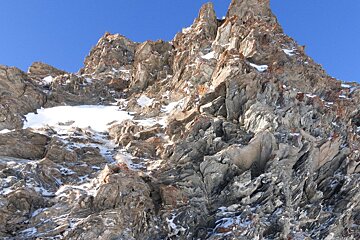 A mountain with a lot of rocks and snow on it