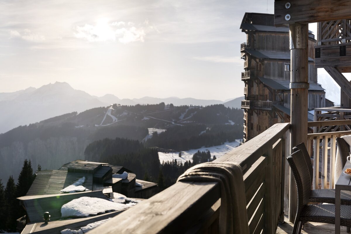 A balcony with a view of a snowy mountain range