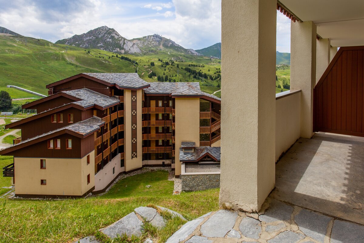 A large building with a mountain in the background