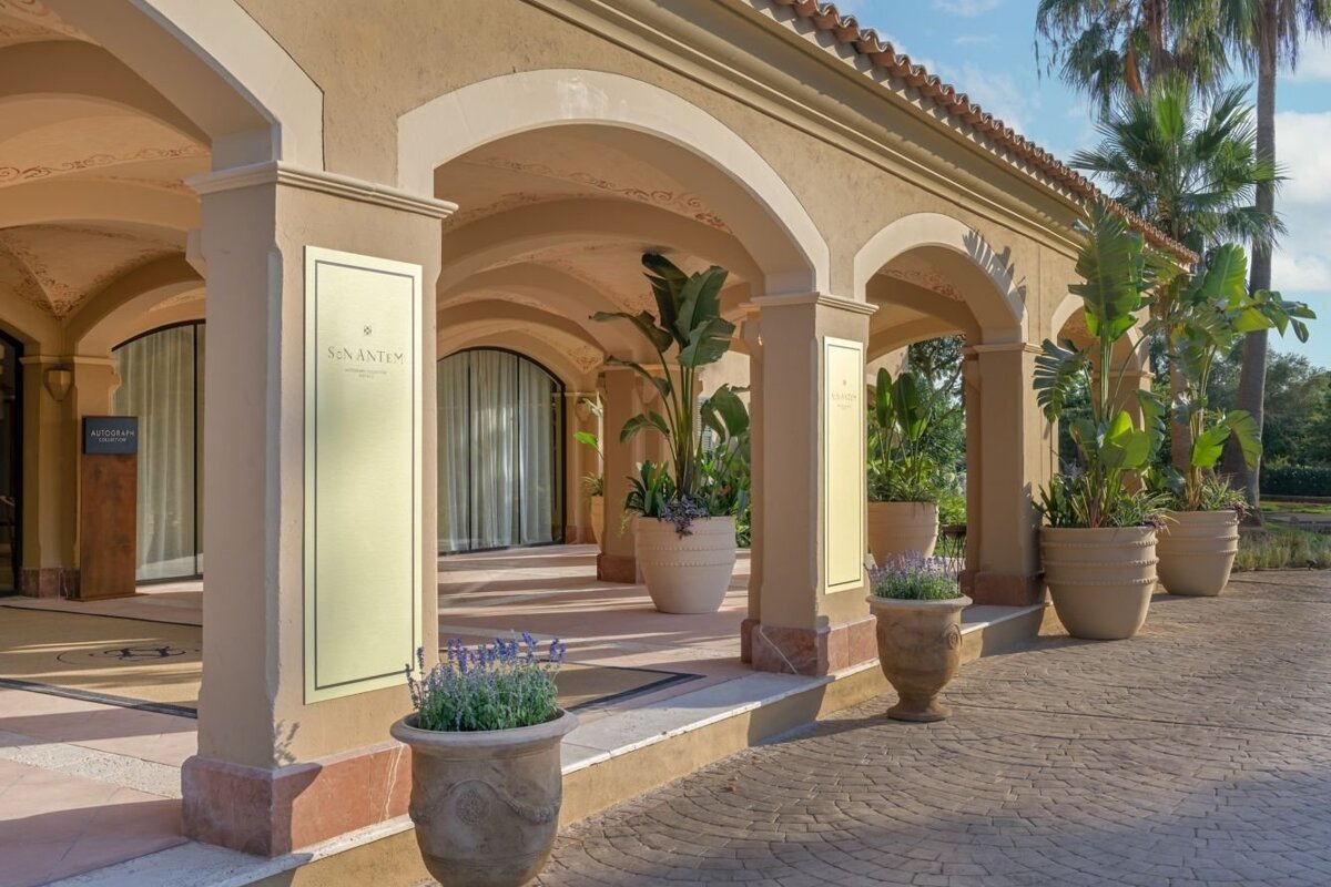An ornate arched building entrance, likely a hotel (