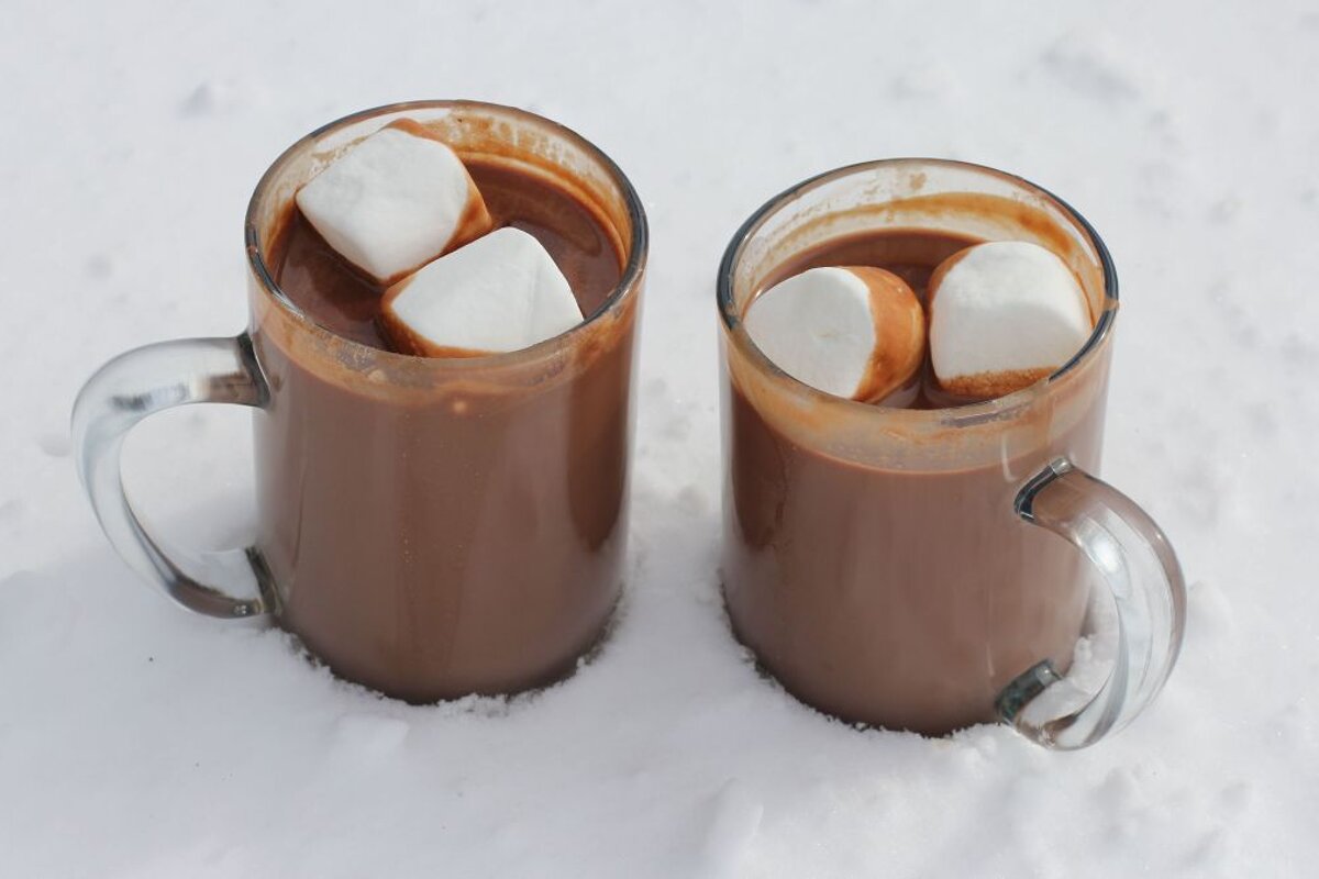 Mugs of hot chocolate in the snow