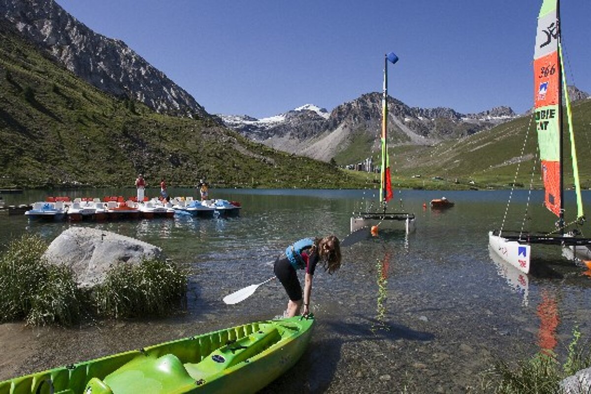 A person in a green kayak is getting ready to paddle