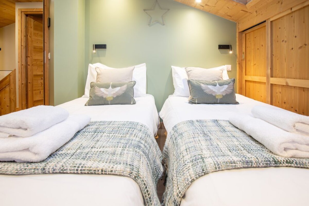 A bedroom with two beds and a star on the wall