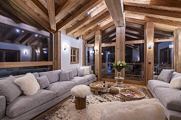 A living room filled with furniture and a bottle of wine