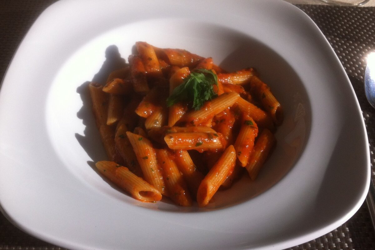 a bowl of pasta with red sauce
