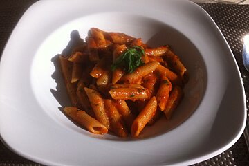a bowl of pasta with red sauce