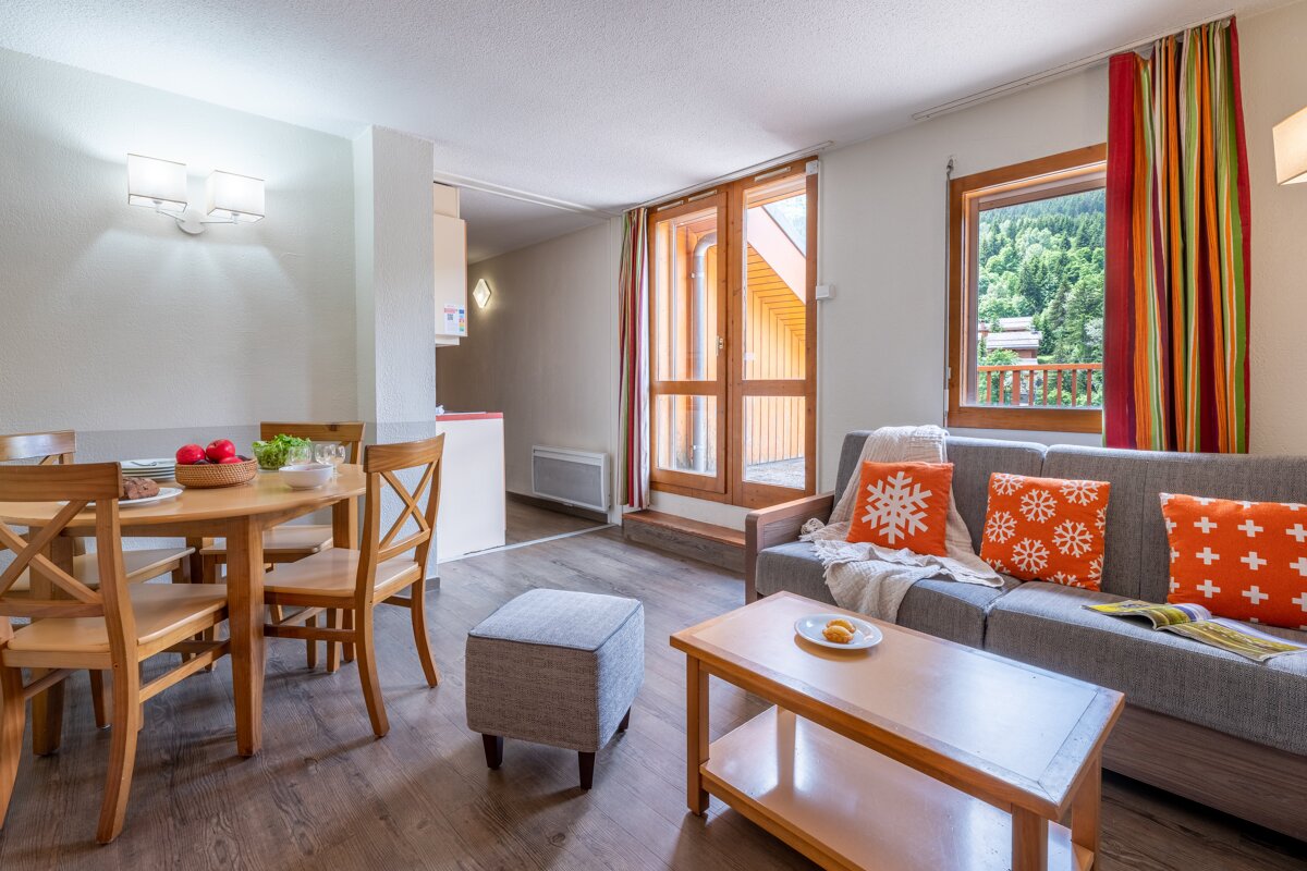 A living room with a couch a table and chairs