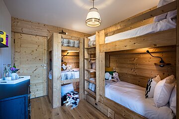 A bunk bed in a room with a sign that says ' a ' on it