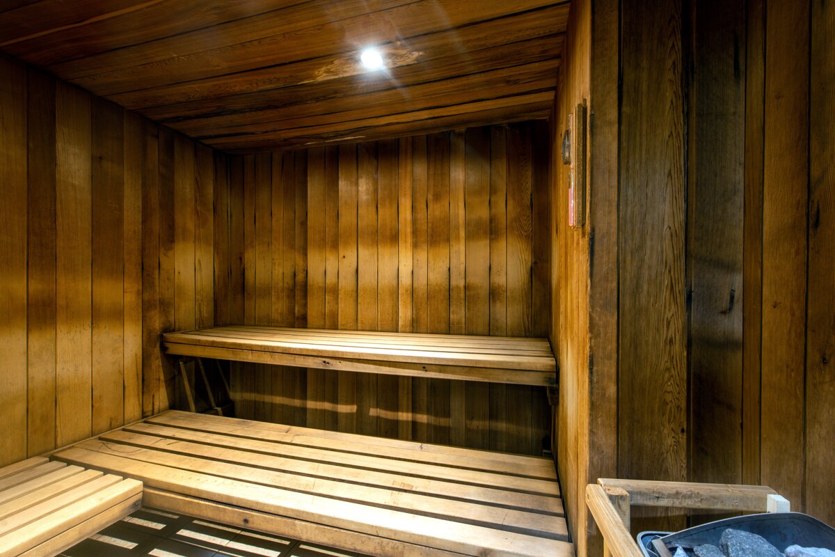 A wooden sauna with a light on the ceiling