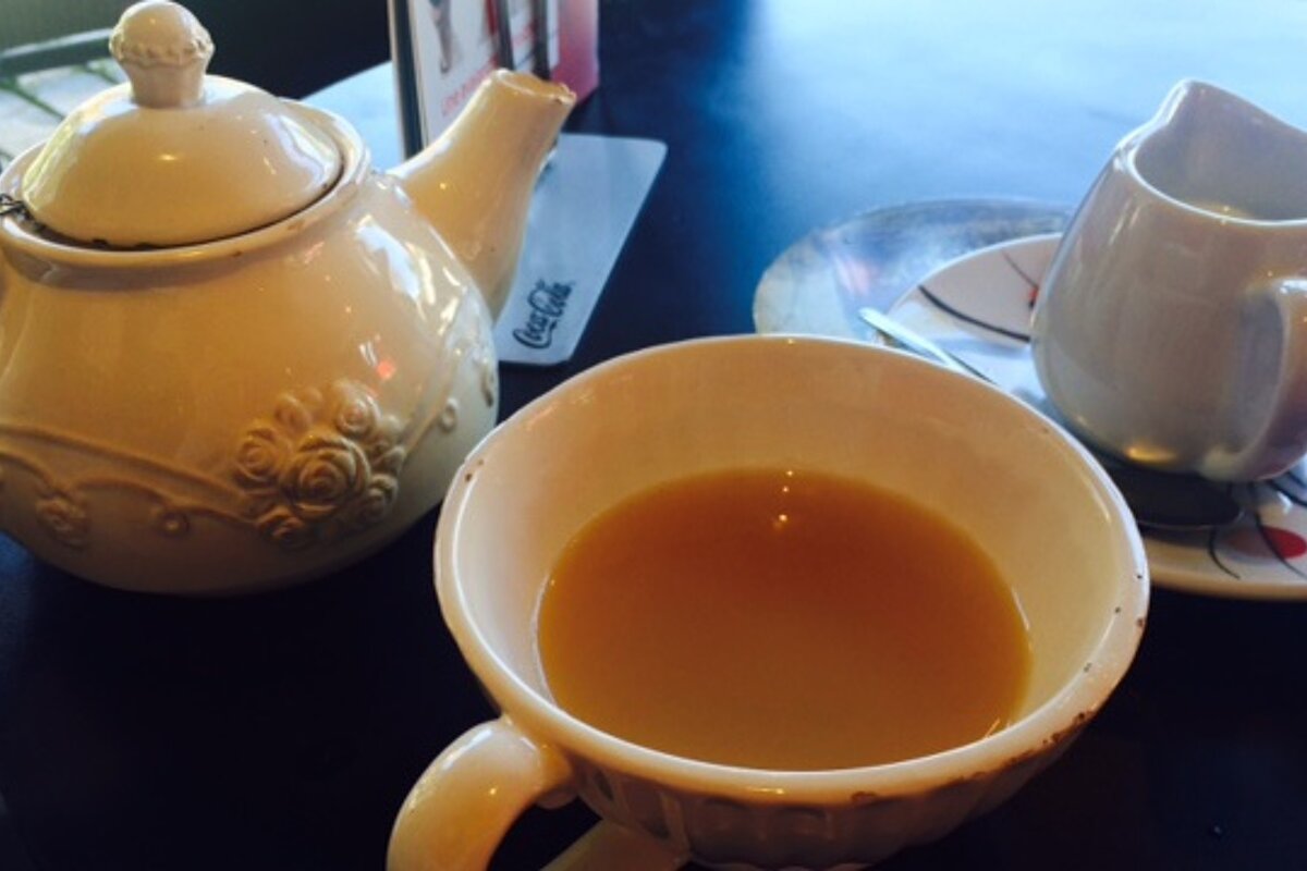 a pot of tea and milk
