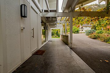 A white house with a driveway leading to it