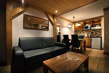 A living room with a couch a table and chairs