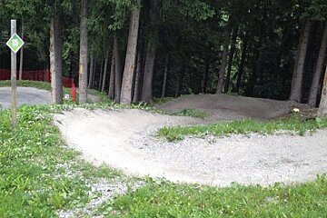 a couple of berms on a green downhill mountain bike track in Meribel