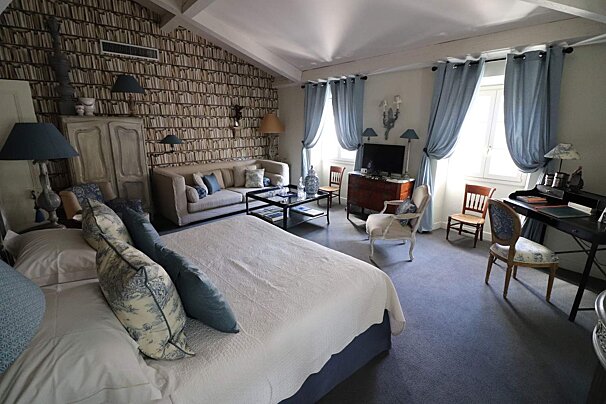 A bedroom with a large bed and a couch