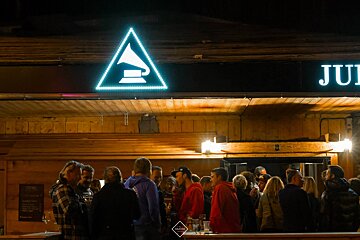 A group of people standing in front of a jui sign